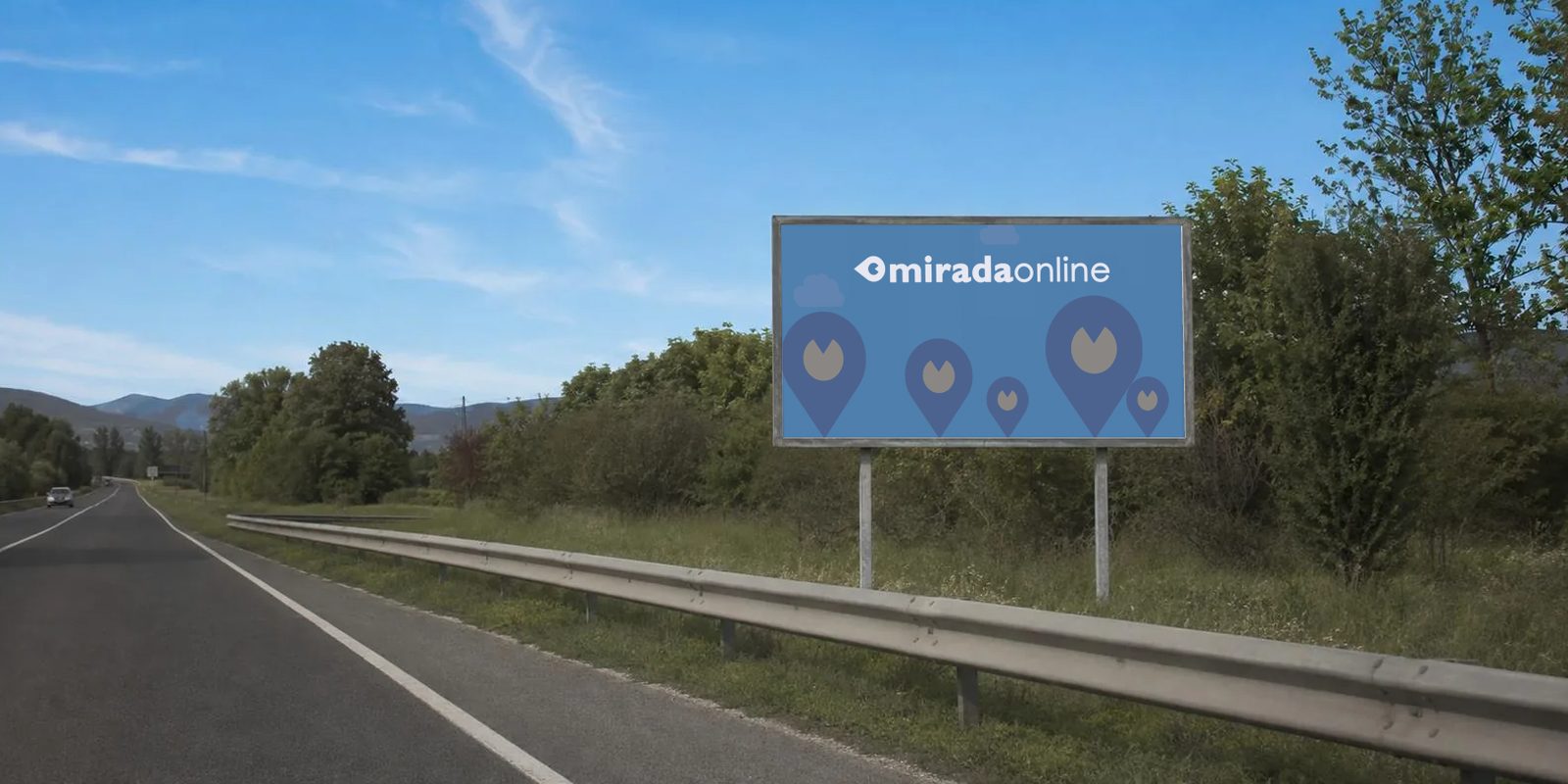 Un cartello 6x3 lungo una strada statale: sul manifesto blu c'è il logo MiradaOnline, in alto, sopra una fila di segnaposto.